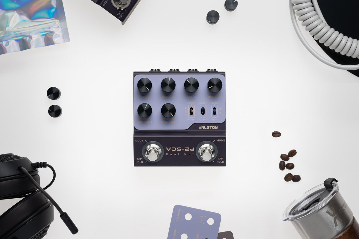 Valeton VDS-2D Digital Dual Modulation Pedal — top view on a white desk with headphones and accessories
