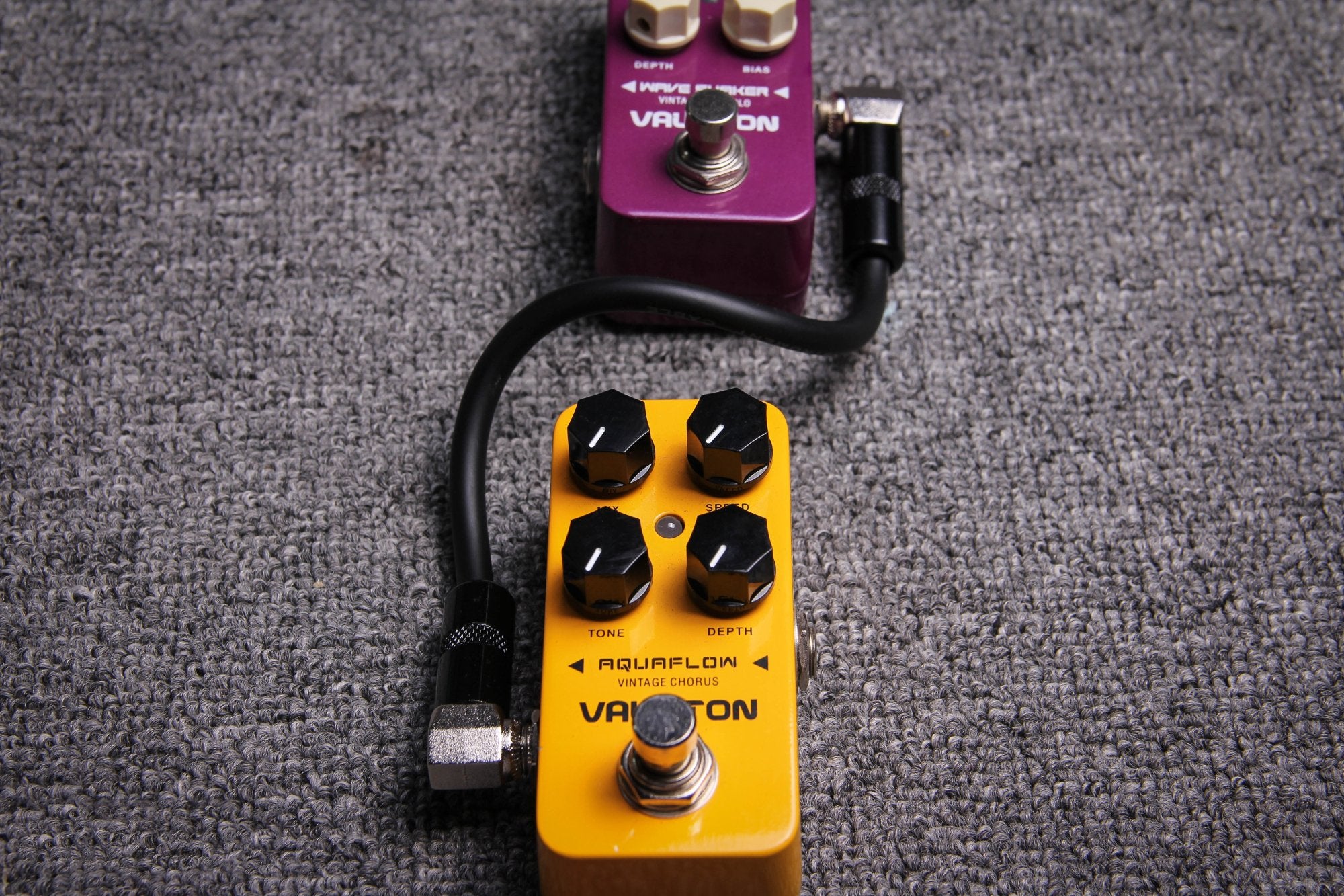 Valeton VPC-1 patch cable connecting a purple pedal to a gold Aquaflow pedal