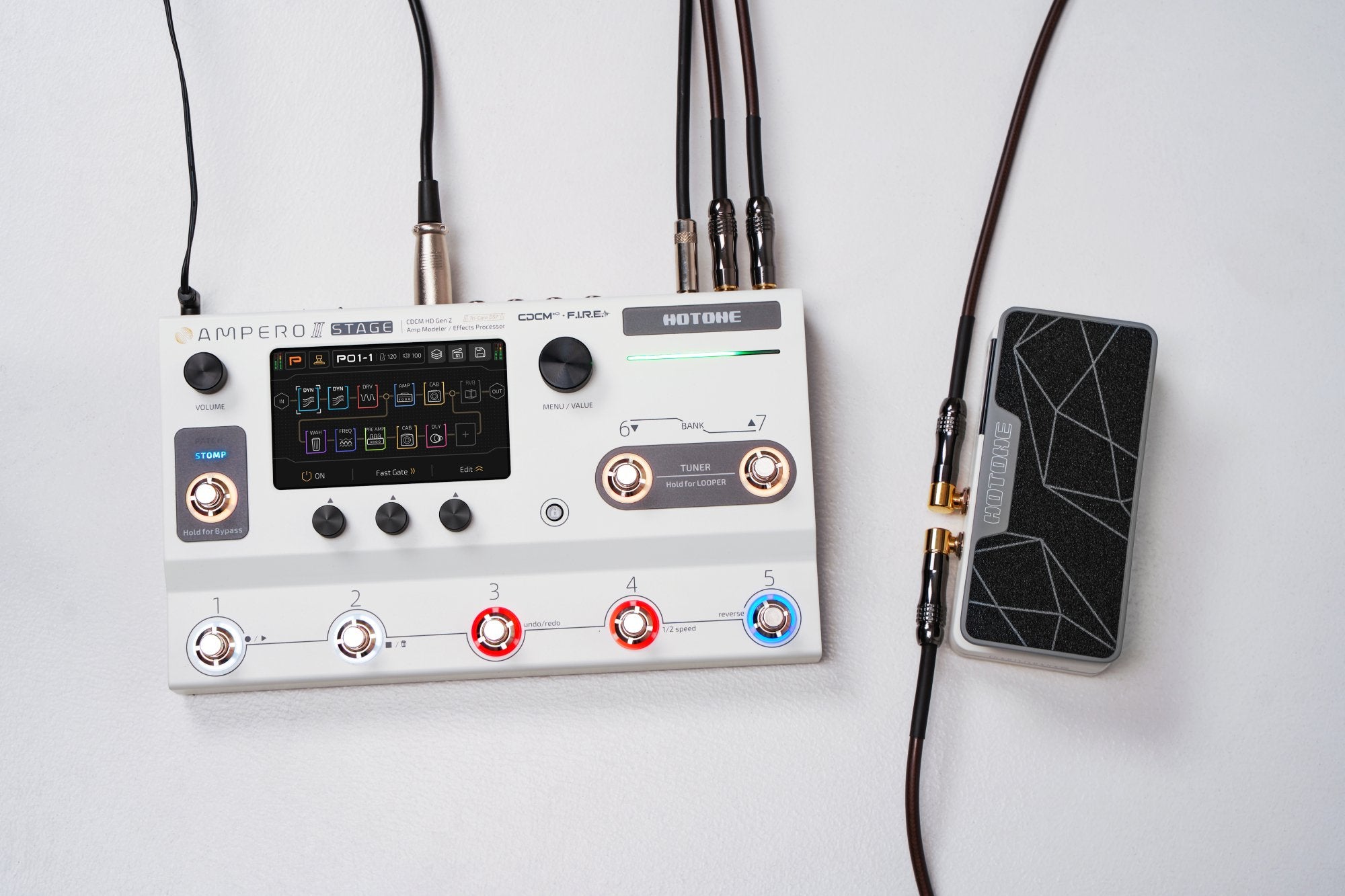 Overhead flat-lay of Hotone Ampero II Press pedal wired into a full pedalboard signal chain