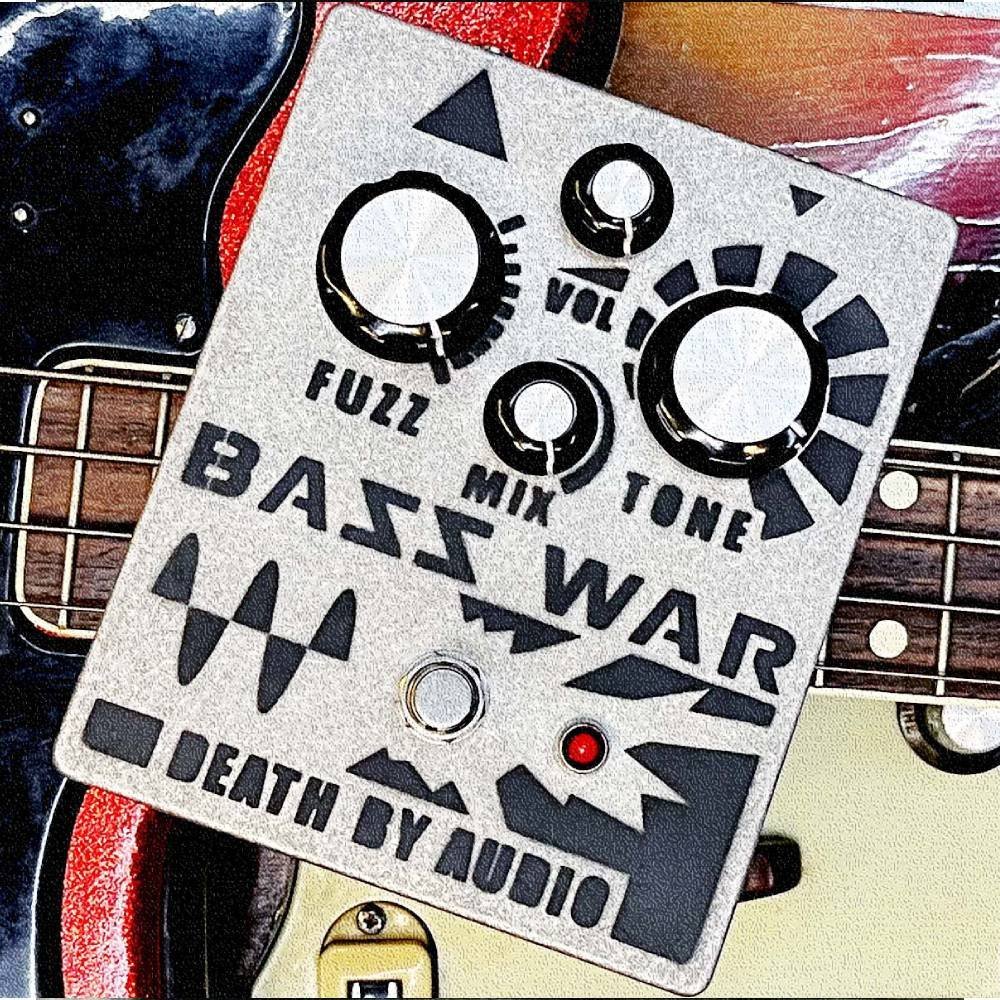 Death by Audio Bass War pedal resting on the body of a sunburst electric bass guitar