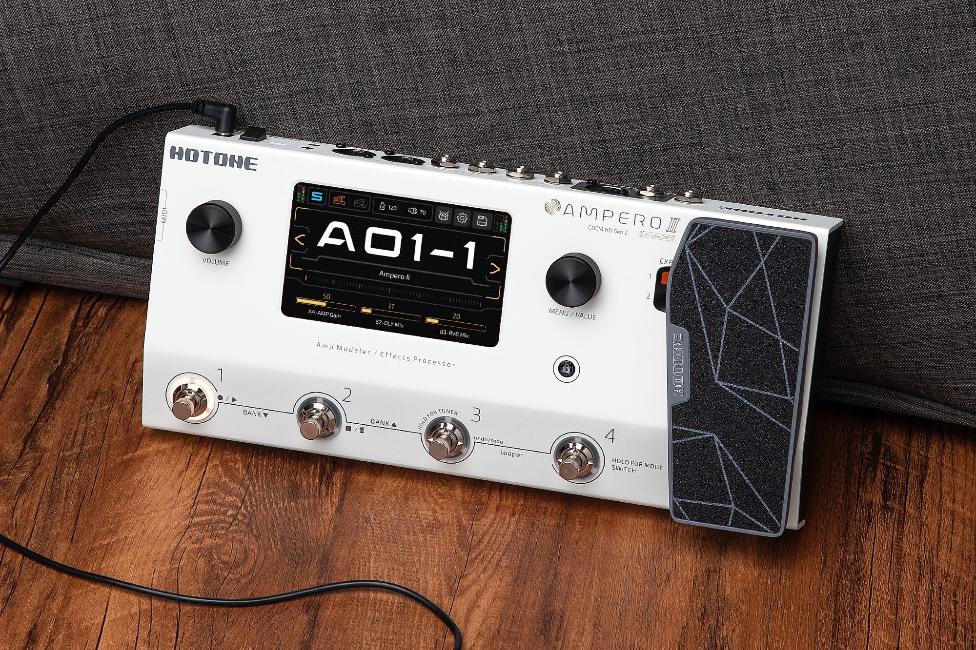 Hotone Ampero II MP-350 amp modeler on a wooden floor in a home lifestyle setting