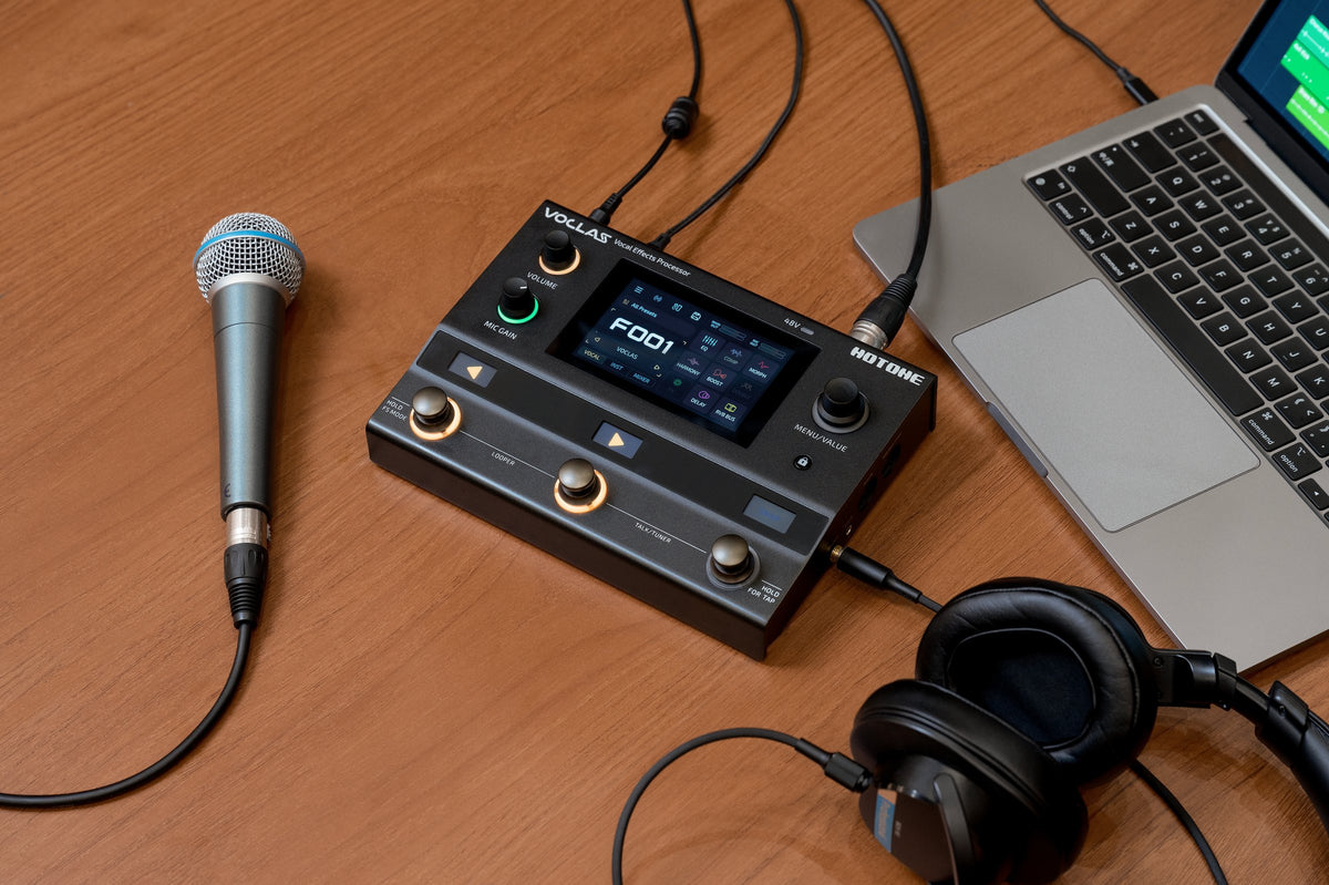 Hotone Voclas VE-300 on a desk with a microphone, laptop and headphones