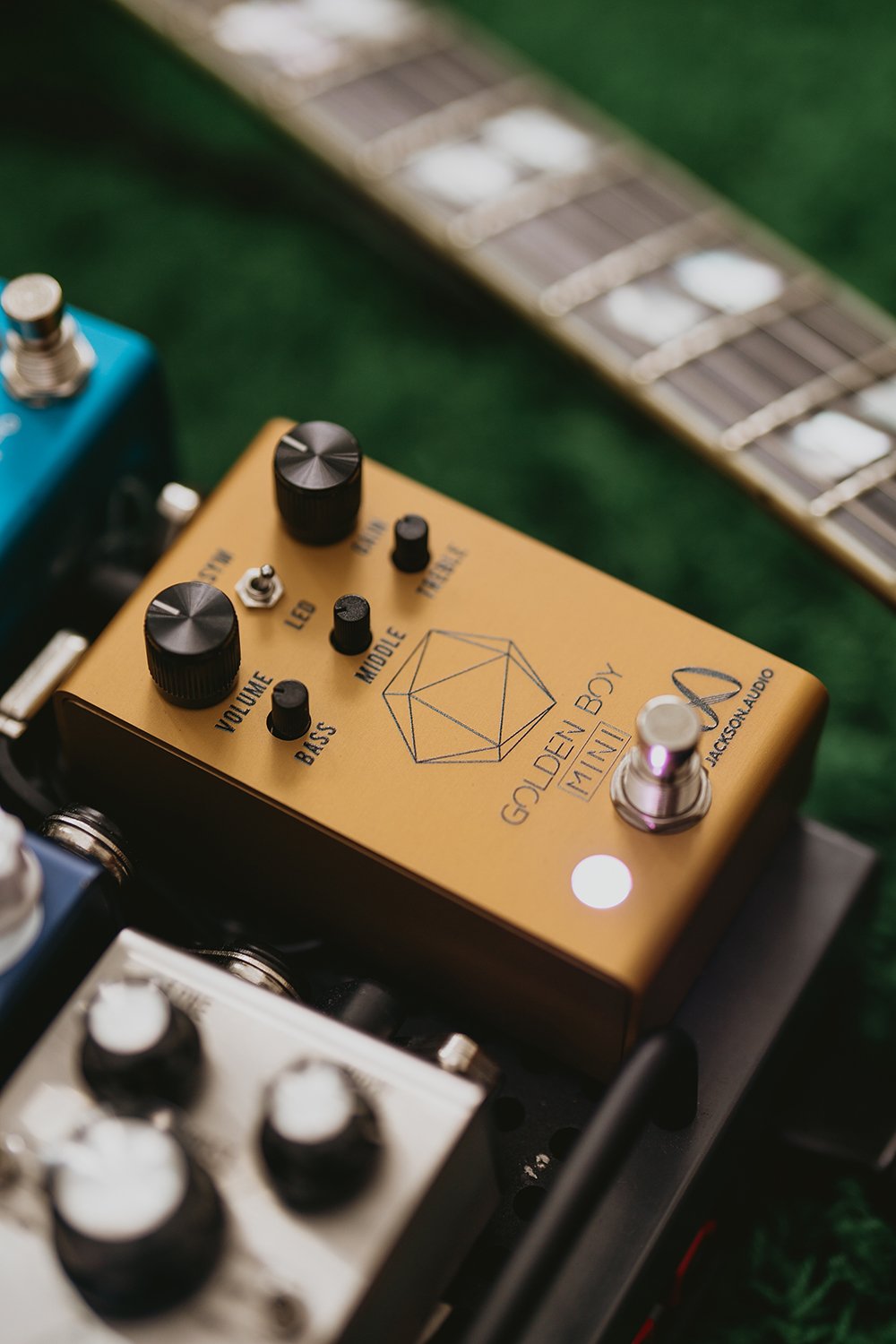 Jackson Audio Golden Boy Mini Transparent Overdrive, Lifestyle photo of the Golden Boy Mini installed on a pedalboard alongside other pedals.