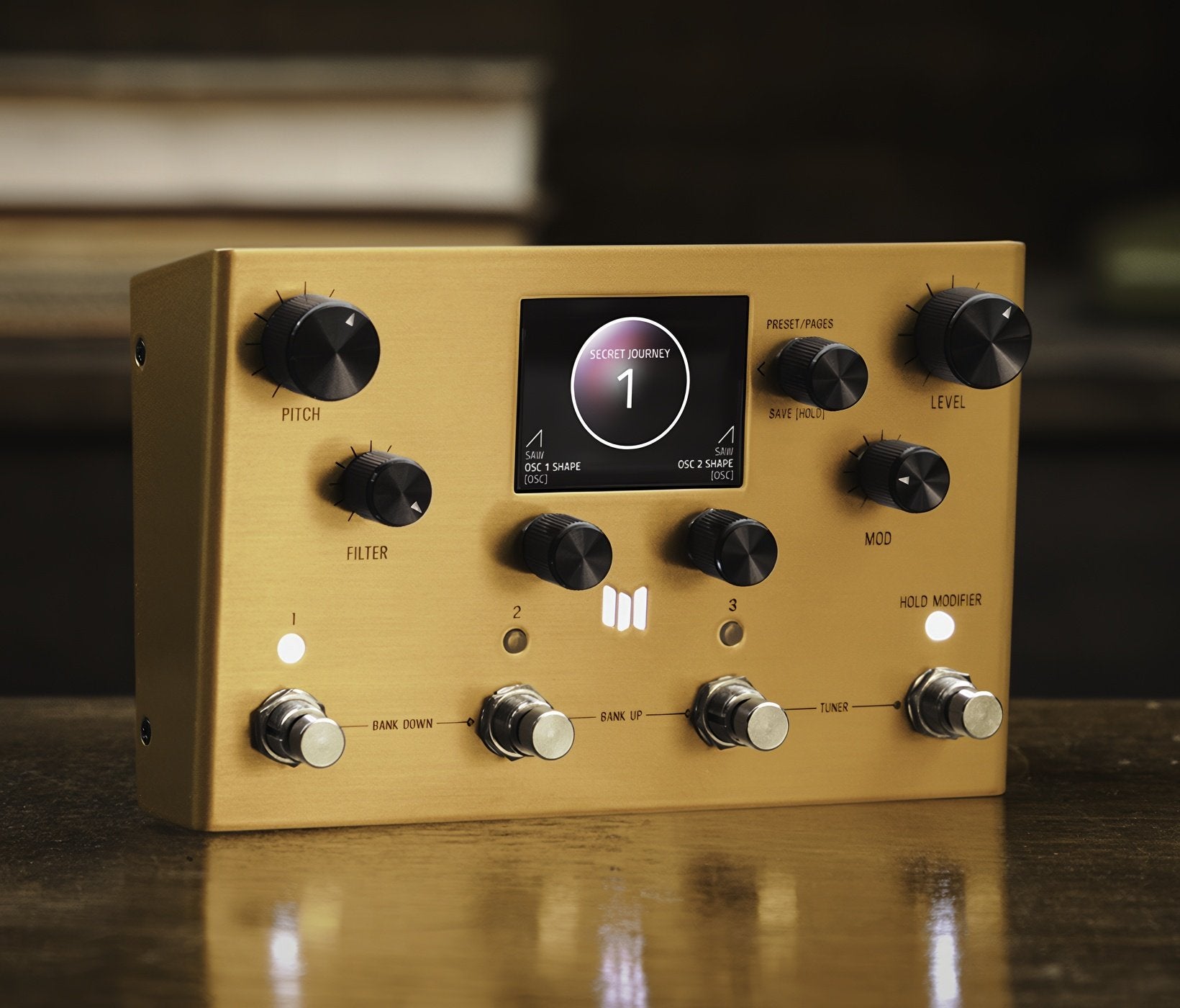 Meris Enzo X synthesizer pedal on a light wood studio table in a brightly lit lifestyle setting