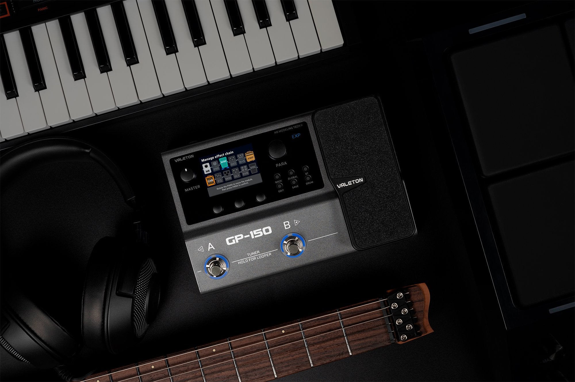 Valeton GP-150 processor in a home studio setup with keyboard and headphones