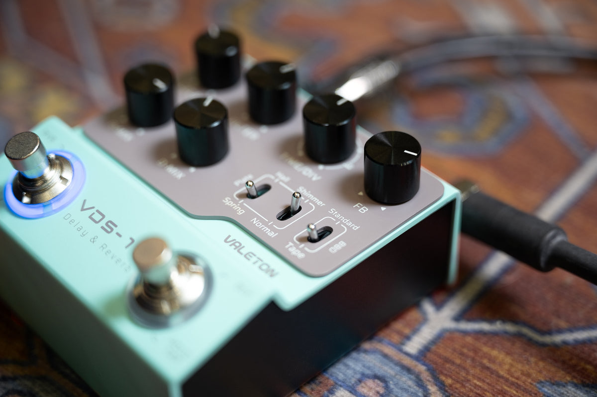 Valeton VDS-1D Digital Delay & Reverb Pedal — close-up of knobs, switches and lit footswitch