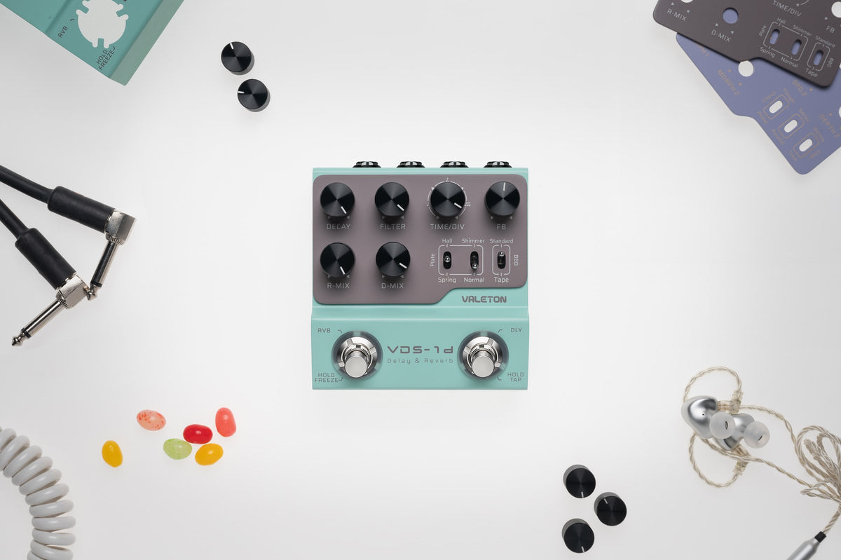 Valeton VDS-1D Digital Delay & Reverb Pedal — top view on a white desk with cables and accessories