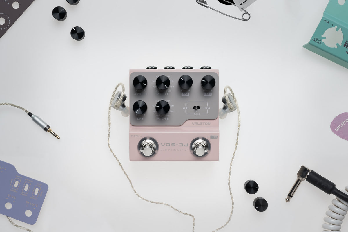 Valeton VDS-3D Digital Dual Pitch-Shifter Pedal — top view on a white desk with in-ear monitors and cables