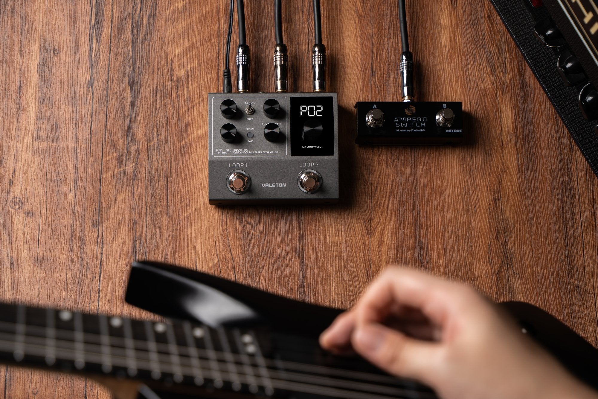 Valeton VLP-200 pedal connected on stage with a guitarist playing nearby