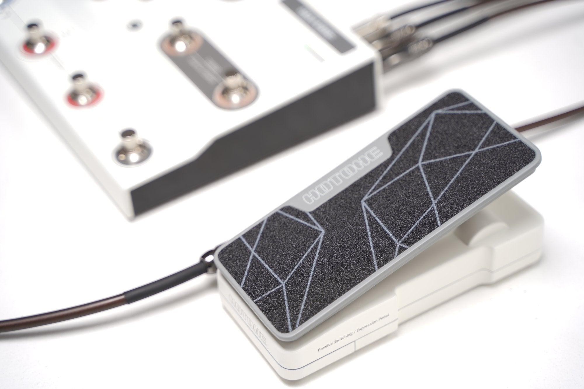 Overhead view of Hotone Ampero II Press pedal connected to a controller via TRS cable