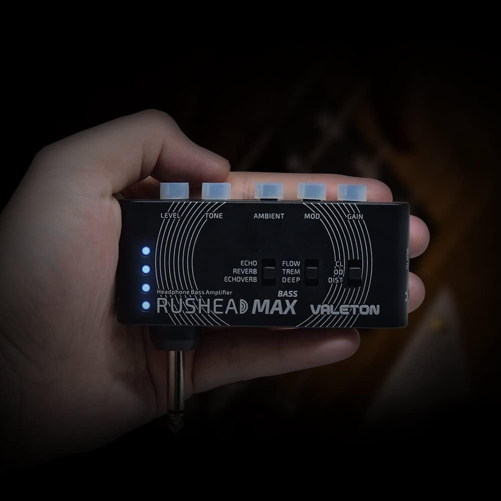 Hand holding the compact Valeton Rushead Max Bass headphone amp