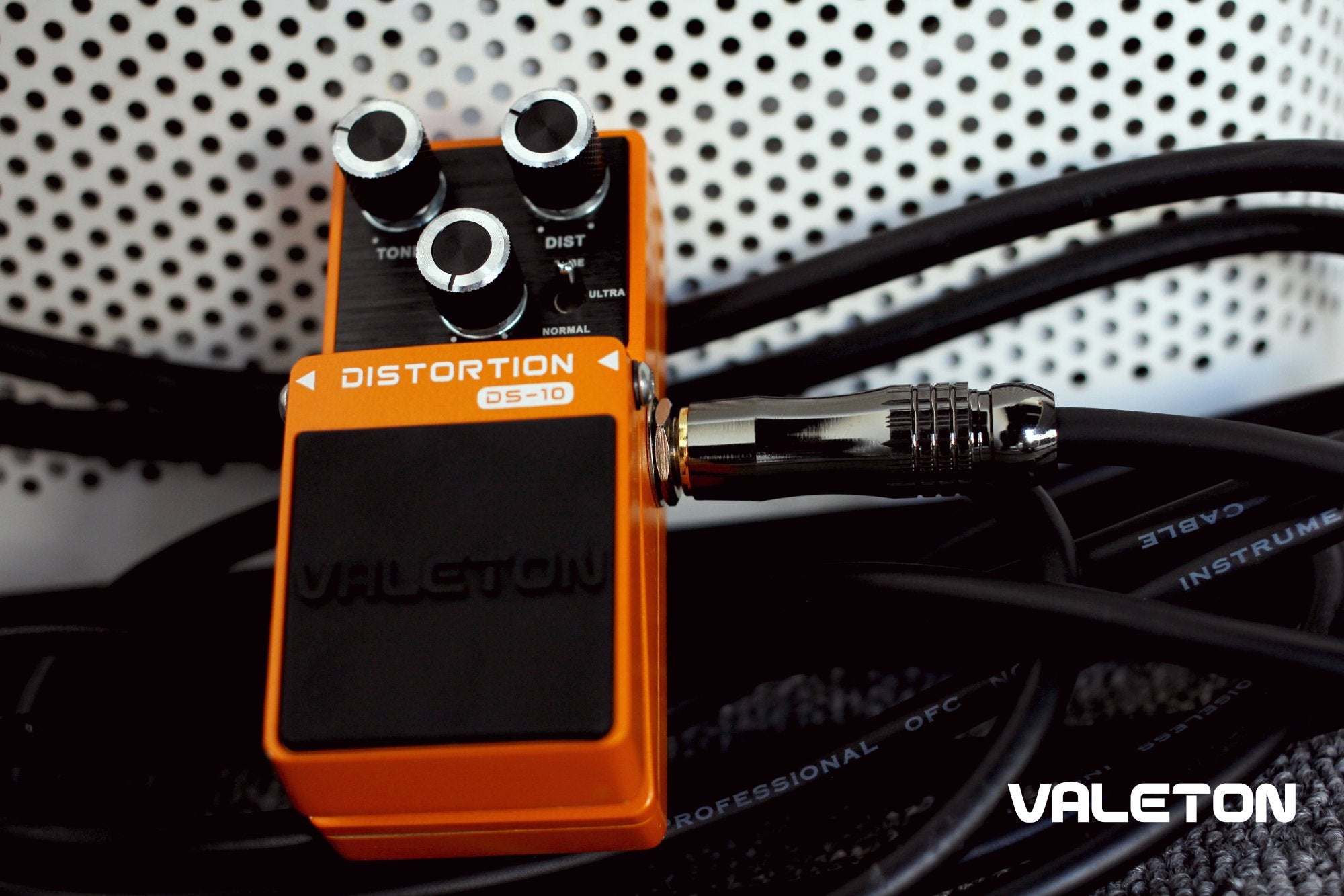 Valeton VGC-3 cable plugged into an orange Valeton distortion pedal
